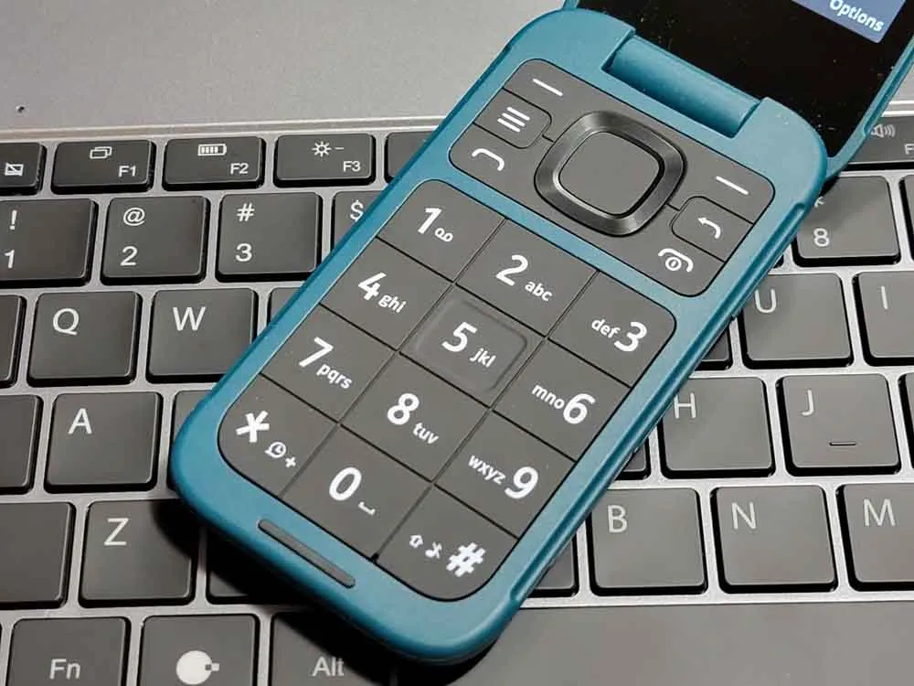 A frustrated person staring at their phone screen with scrambled text and autocorrect suggestions that make no sense